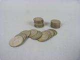 a pile of coins sitting on a table next to a pile of coins