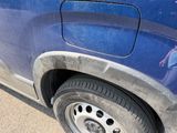a close up of a car ' s tire on the side of the road