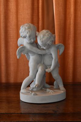 a statue of two cherenshes hugging on a table