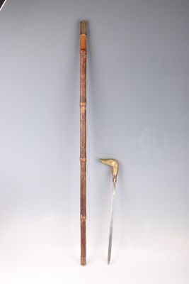 a wooden stick and a knife on a white surface