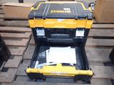 yellow and black tool box sitting on pallets with papers in it
