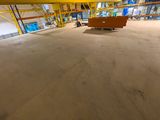 an image of a large warehouse with a bench in the middle of the room