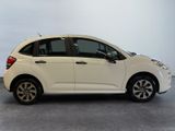 a picture of a small white car parked in a garage