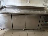a stainless steel counter in a kitchen with a sink