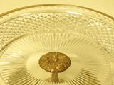 a glass plate with a gold decoration on it