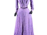 purple dress on a mannequin stand with gloves and gloves