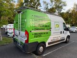 a green and white van parked in a parking lot