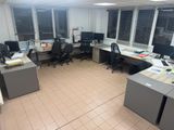 an office with a lot of desks and computers