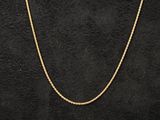 a gold chain on a black background