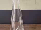 a clear glass vase sitting on a wooden table