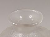 a clear glass vase sitting on a white surface