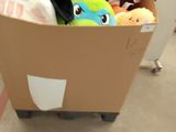 a cardboard box with a stuffed animal inside of it
