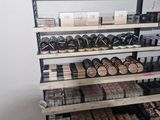 many shelves of makeup products on the shelves in the store