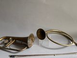 a trumpet, a horn, and a stick on a table