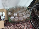 a box full of empty glasses and a bicycle tire