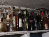 many bottles of alcohol on a shelf in a room