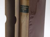 a book in a cardboard box with a brown cover