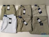 five pairs of men ' s khaki pants with tags on them