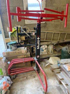 a red crane that is sitting in a garage