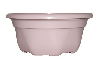 le grand pot rose est posé sur une surface blanche