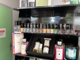 many bottles of nail polish on a shelf in a store