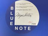 a close up of a label on a blue surface with a blue background