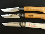 four different types of knives are lined up on a black surface