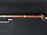 an old rifle with a wooden barrel and a metal handle