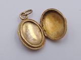 an image of a gold locke with a pearl inside on a white surface