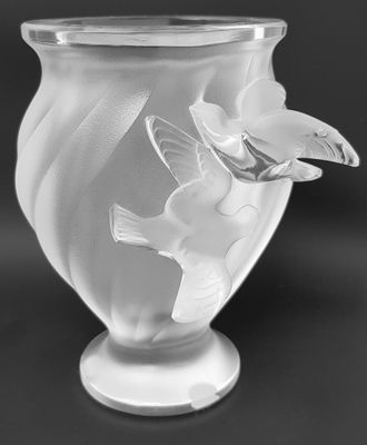 black and white photograph of a vase with a bird on it