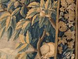 a tapestry hanging on the wall with a bird on it