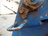 a blue fire hydrant with a rusted metal latch on it