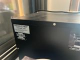a plate of food sitting on a table next to a microwave