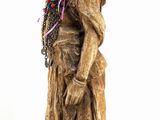 statue of a woman carrying a pot on her head with a scarf around her neck