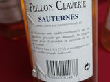 a bottle of wine sitting on a table next to a bottle of wine