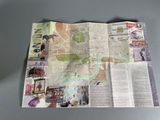 a folded map on a table with pictures on it