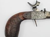 an old gun with a wooden handle on a white surface