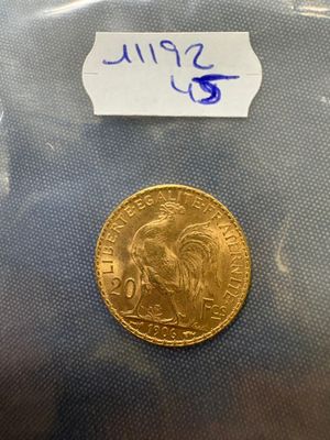 a close up of a gold coin with a label on it