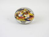 glass marble ball with multicolored design on white surface
