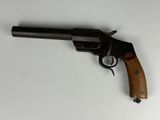 a close up of a gun on a table with a white background