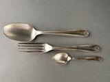 three spoons and a fork on a table