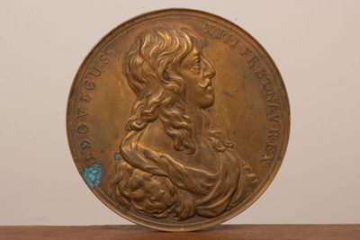 l'image d'une pièce d'or sur laquelle figure le visage d'une femme