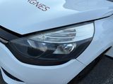 a white car that has a red sticker on the hood