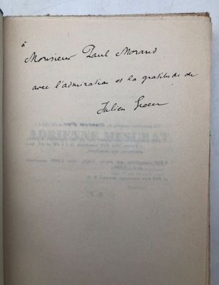 an open book with handwriting on it sitting on top of a table