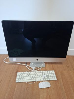 a computer with a keyboard and mouse on a wooden floor