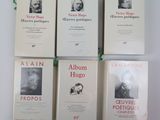 four books on a white table with a green ribbon
