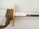 a close up of a sword with a rope attached to it