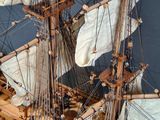a wooden model of a sailing ship on a table
