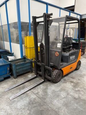 a fork lift truck parked in front of a building