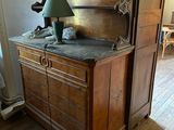 a wooden cabinet with a lamp on top of it
